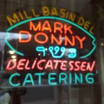 lit up sign in the window of the mill basin deli in new york