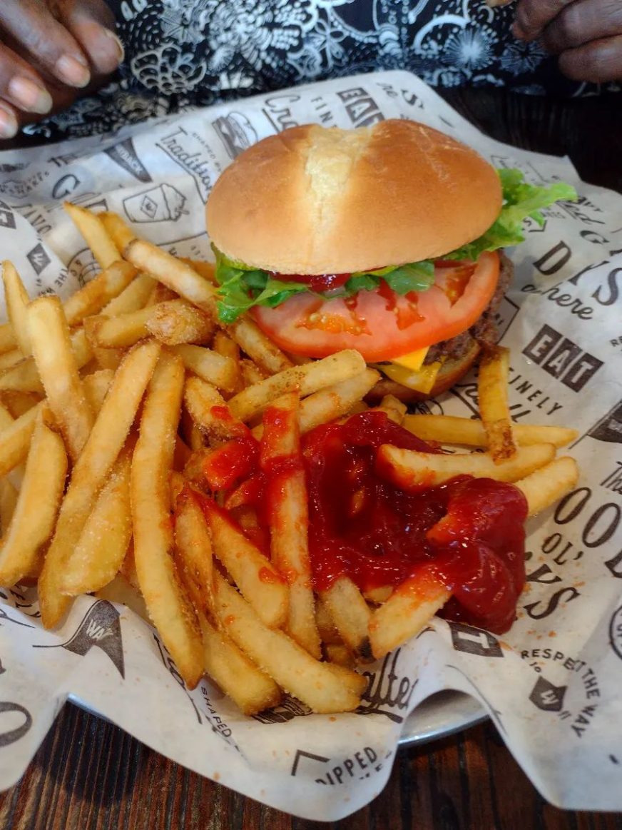 Wayback Burgers, Wake Forest, NC Cheeseburger with lettuce and tomato served alongside French fries topped with ketchup