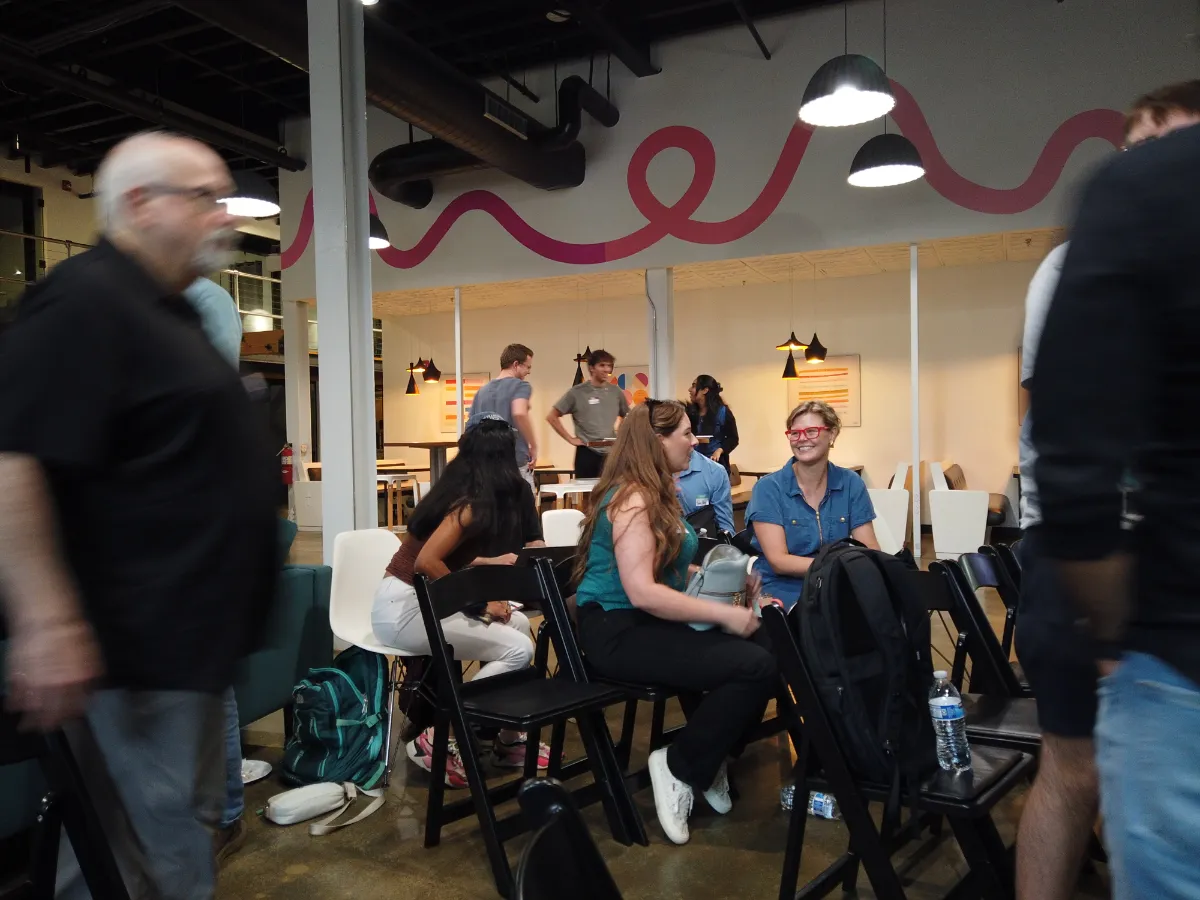 People sitting and talking in a modern, industrial-style event space