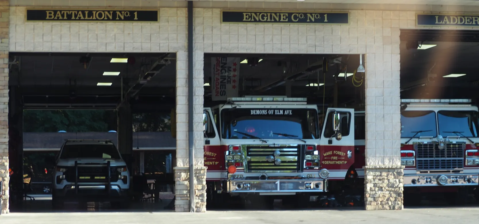 Wake Forest Fire Department station with vehicles parked inside open bays labeled Battalion No. 1 and Engine Co. No. 1